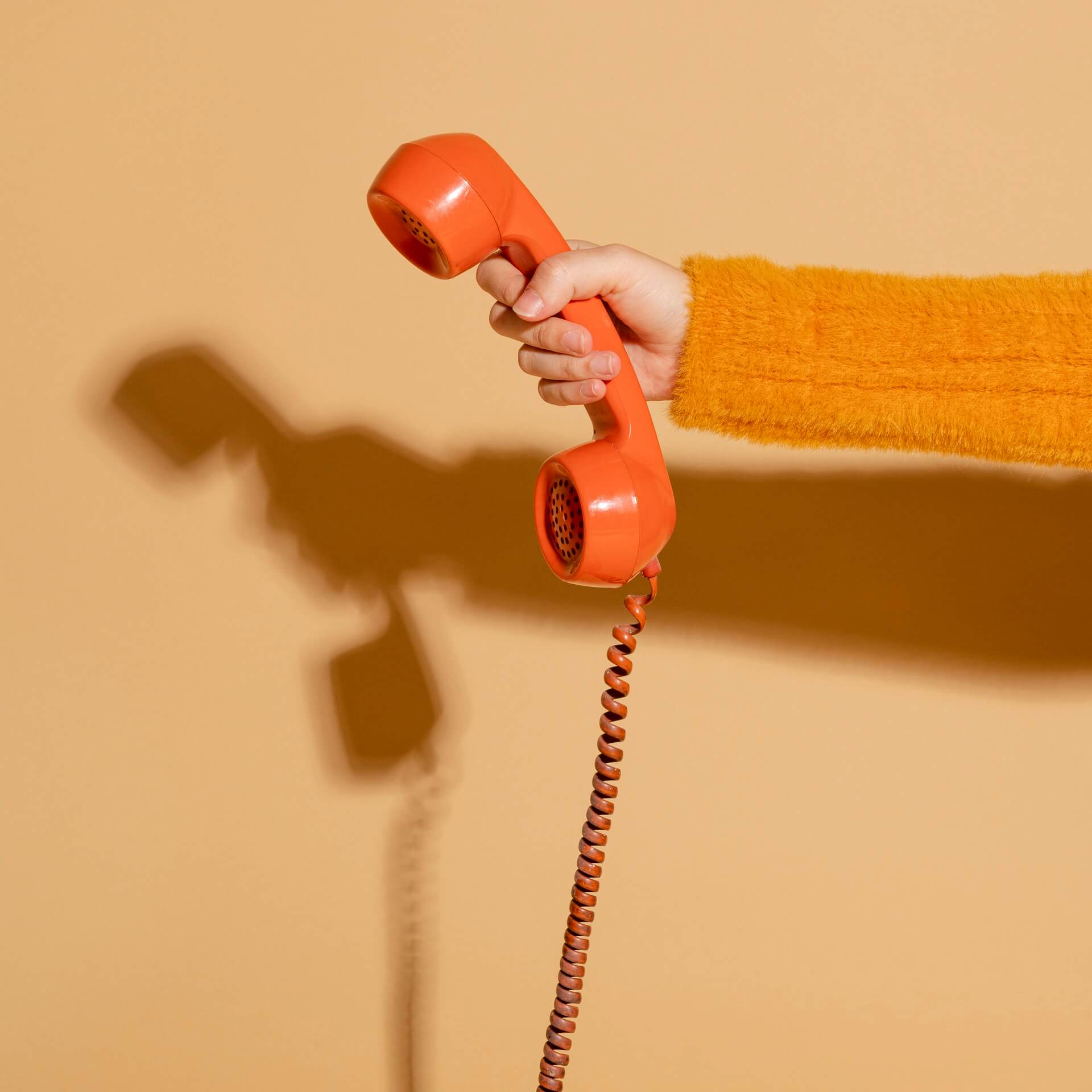 woman-answering-corded-retro-phone
